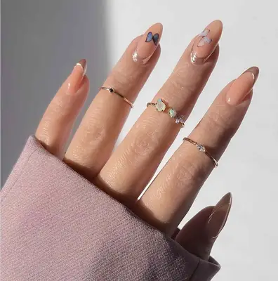 A peach manicure with butterflies