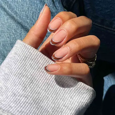 Brown French manicure with baby blue outlines on tips