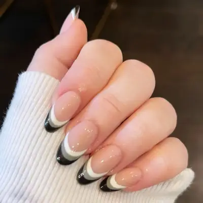 Grayscale French manicure with triple-layered white, gray, and black tips