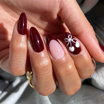 Cherry red French manicure with white cherry design on accent nail