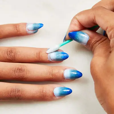 Woman cleans up her cuticles