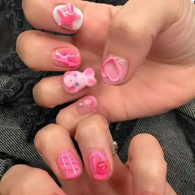 a mismatched pink manicure with a 3D bunny
