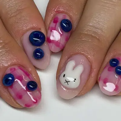 a plaid and blueberry manicure with bunny accents