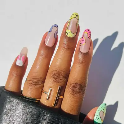 a speckled egg negative space manicure with bunny accent nail