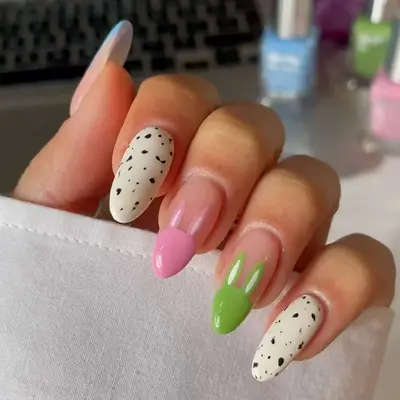a manicure with speckled egg and bunny designs