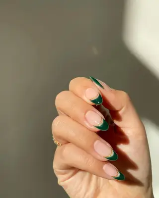 Dark forest green French manicure with gold band accent