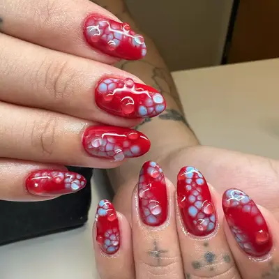 Close up of nude short nails with gold stars at the cuticle