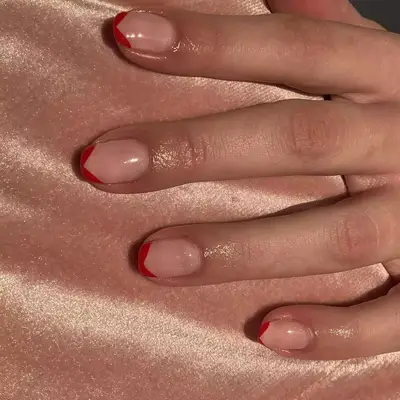 Close up of a short V-shaped French manicure