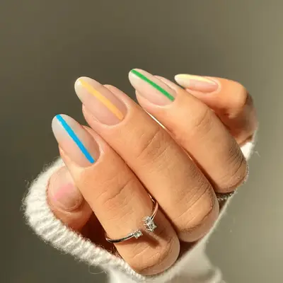 Manicure with colorful thin stripes down each nail