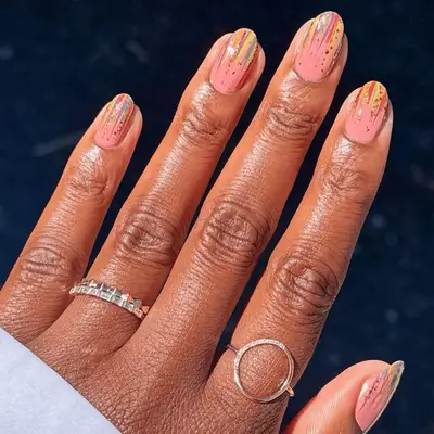 Manicure with micro stripes in a dripping effect against a pink base