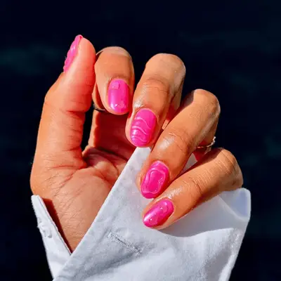 Short, hot pink 3D nails with clear builder gel designs