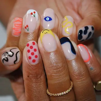 Hand with different nail art on each nail