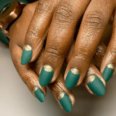 Emerald green matte nails with gold half moon designs