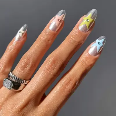 model with silver nails with pastel stars and matching rhinestones