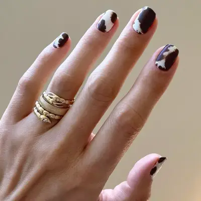 model with cowhide print nails