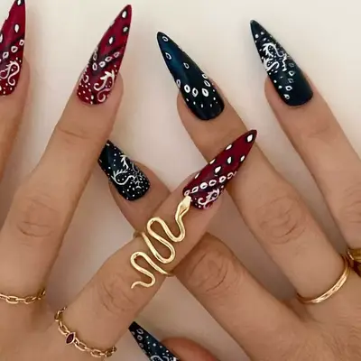 model with red and black nails with bandana paisley design