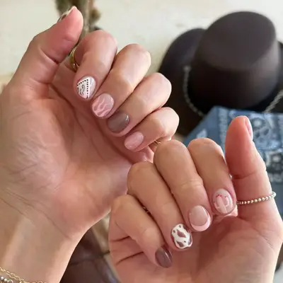 model with nails with pink flames, banana details, soft brown polish, and pink cactus