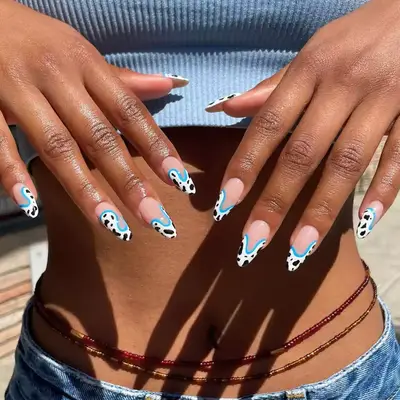 model with cow print French tips with aqua blue outline