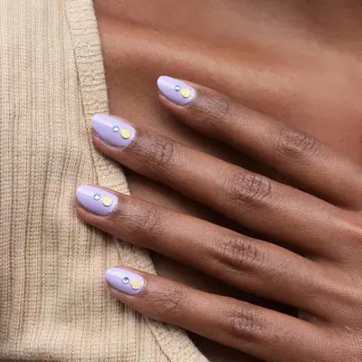 Close up of a lavender mani with subtle gem details