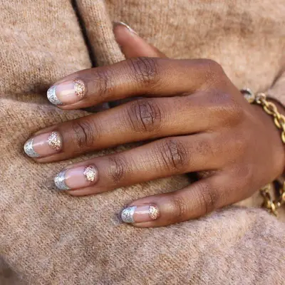 A manicure with silver and gold polish