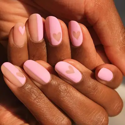 Close up of a baby pink manicure with neutral colored details