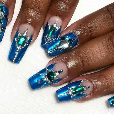 A sapphire blue manicure with jewel details