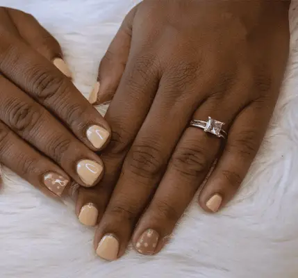 Close up of an aqua blue manicure with gold details