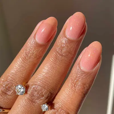 nude syrup nails with glitter top coat