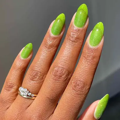 neon green syrup nails topped with silver glitter
