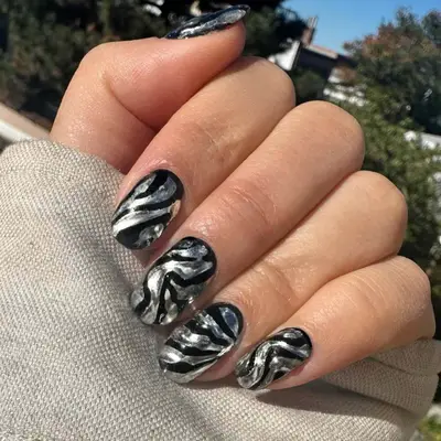 Black and silver zebra print manicure.