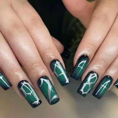 Green halo aura nails with various numbers on each finger in silver.