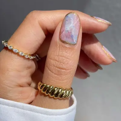 Moody Opal Nails in shades of blue, pink, and purple