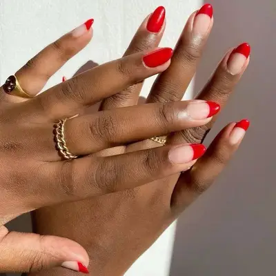 Red French manicure with all-red accent nails