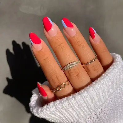 Negative space manicure with bright red and pastel blue split tips