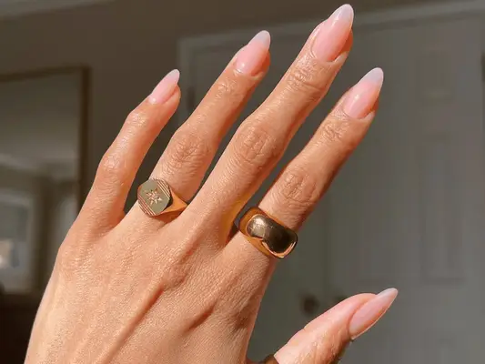 woman with long baby pink sheer nails