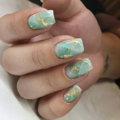 Jade green nail art with gold foil