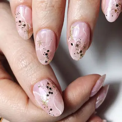 Rose quartz nail design with gold sparkle and glitter details