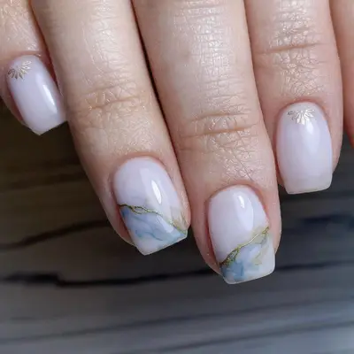 Pearlescent manicure with blue-tinged marble nail tips