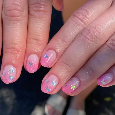pink shimmer airbrush nails with holographic butterflies
