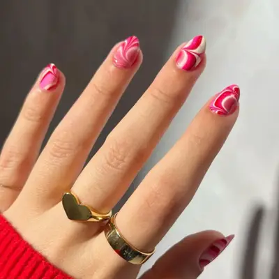 Short almond shaped nails with pink water marble design.