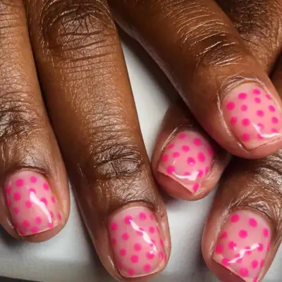 Pink polka dots on short square nails.