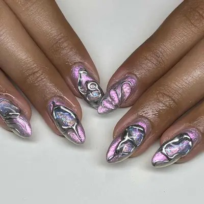 Person with pink chrome nails and silver futuristic designs