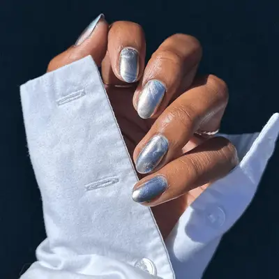 Person with square-shaped white chrome nails