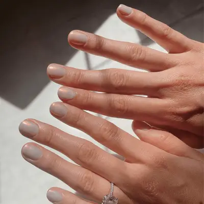 Person with shiny nails with chrome stickers