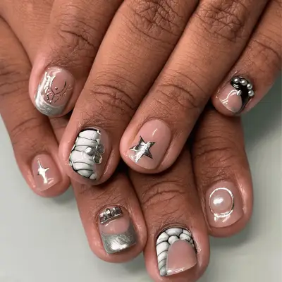 Person with chrome nails with rainbow pastel French tips