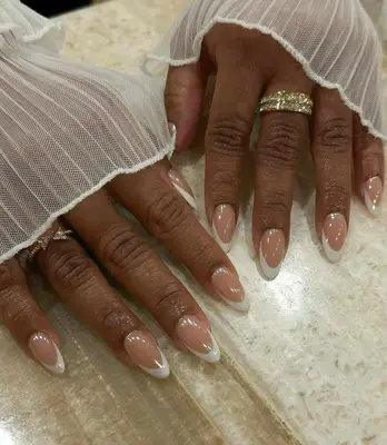 A French manicure topped with chrome powder. 