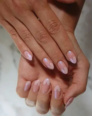 A pink glazed manicure with hearts. 