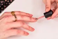 A parson applying a Deborah Lippmann Gel Lab Pro Nail Color polish to their finger