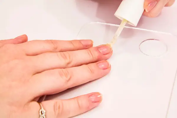 A person using a base coat of OPI GelColor Polish on their nails