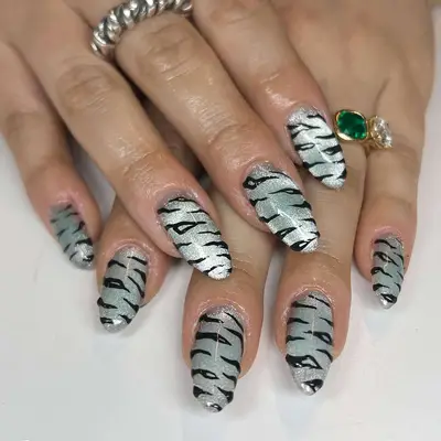 a silver velvet manicure with tiger stripes